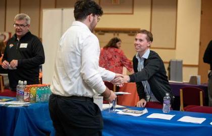 Student at career fair shaking hands