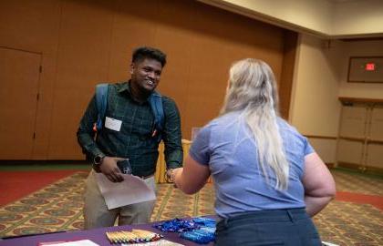 Student shaking hands with recruiter at job fair